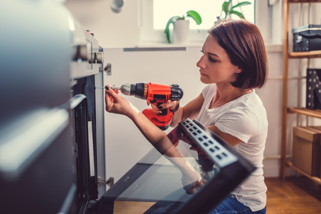 A woman making hole with drill