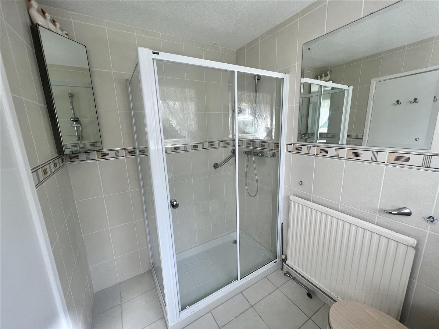 a bathroom with a separate shower area
