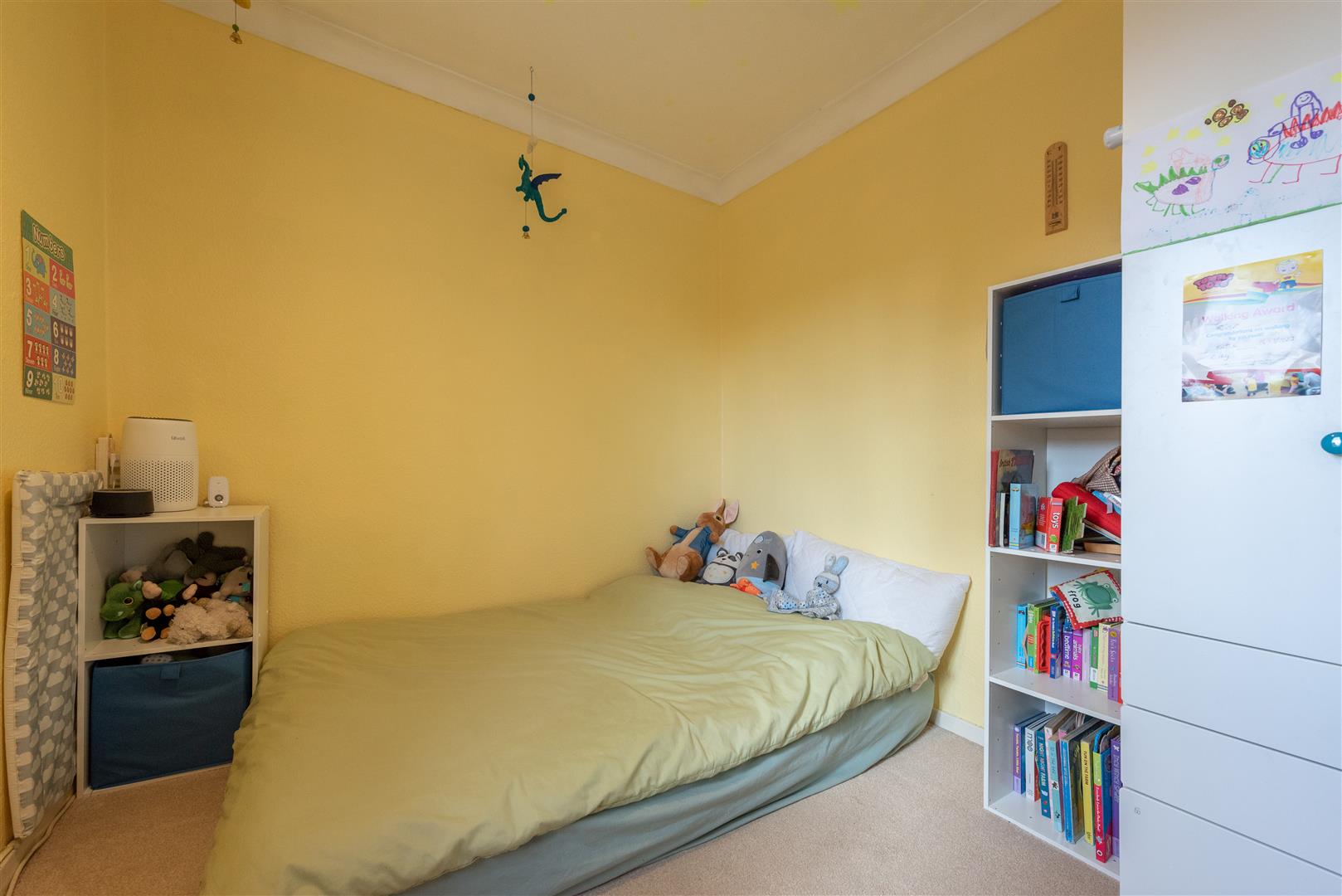 a room with toys and a bed for kids