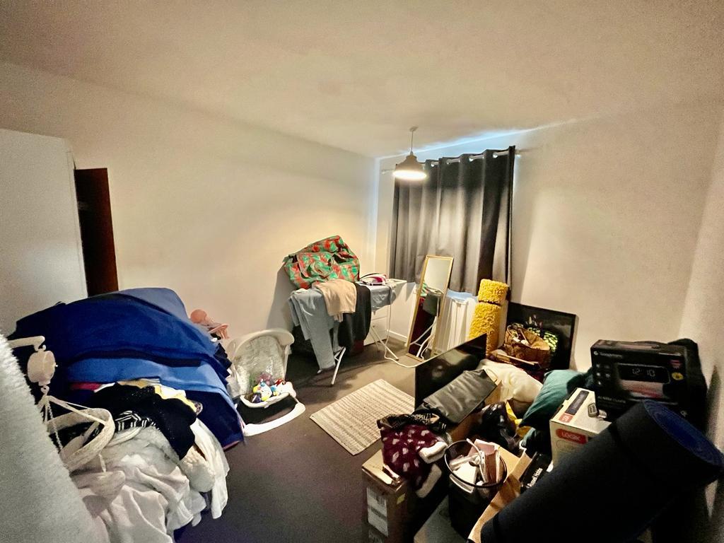 a room with lots of clothes and other items