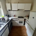Inside view of a small kitchen with white interior